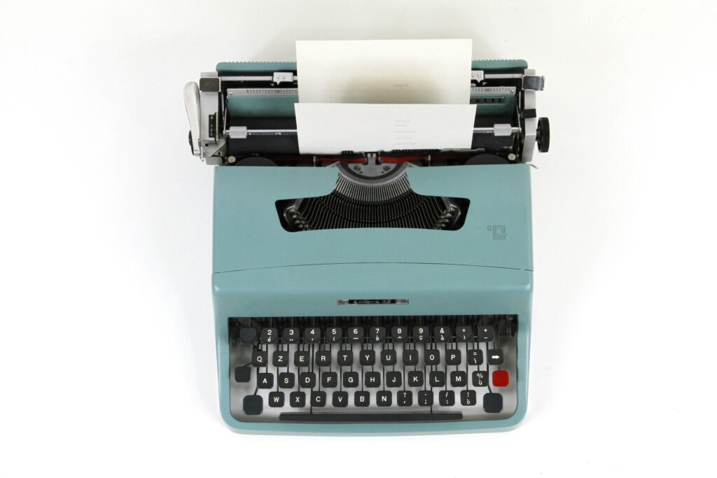 Vintage typewriter with a blank page, representing a stalled novel draft